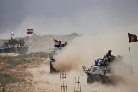 Iraqi federal police advance with Shi'ite fighters towards Falluja, Iraq, May 24, 2016. PHOTO BY REUTERS/Thaier Al-Sudani