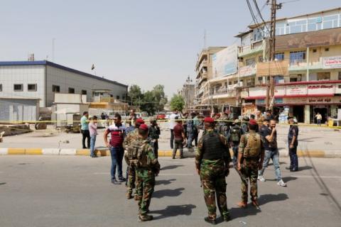 Iraqi security forces gather at the site of a suicide bomb blast in Baghdad al-Jadida, Iraq, September 27, 2016. PHOTO BY REUTERS/Ahmed Saad