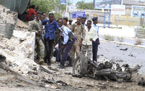 Somali government soldiers take their positions during a clash with Al Shabaab militants outside the Parliament buildings in the capital Mogadishu