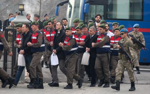 Turkish soldiers accused of attempting to assassinate President Tayyip Erdogan on the night of the failed last year's July 15 coup, are escorted by gendarmes as they arrive for the first hearing of the trial in Mugla, Turkey, February 20, 2017. PHOTO BY REUTERS/Kenan Gurbuz