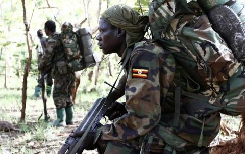 Ugandan soldiers, who are tracking down Lord's Resistance Army (LRA) fugitive leaders, walk in a forest bordering Central African Republic (CAR), South Sudan and Democratic Republic of Congo, near river Chinko, April 19, 2012. PHOTO BY REUTERS/Stringer