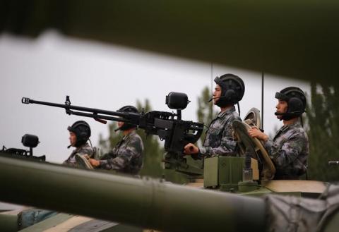 Soldiers of People's Liberation Army (PLA) stand inside tanks at a drill during an organised media tour at a PLA engineering academy in Beijing