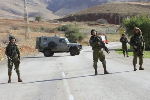 Israeli soldiers stand guard near the scene where two Palestinian men were shot dead by Israeli troops at a checkpoint in the West Bank, January 9, 2016. PHOTO BY REUTERS/Abed Omar Qusini