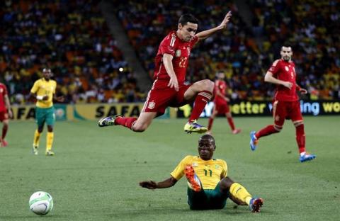 Spain's Jesus Navas (top) is challenged by South Africa's Thabo Matlaba during their international friendly soccer match at Soccer City in Johannesburg