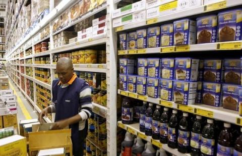 A worker arranges goods at a Makro branch of South African retailer Massmart in Johannesburg, May 31, 2011. PHOTO BY REUTERS/Siphiwe Sibeko