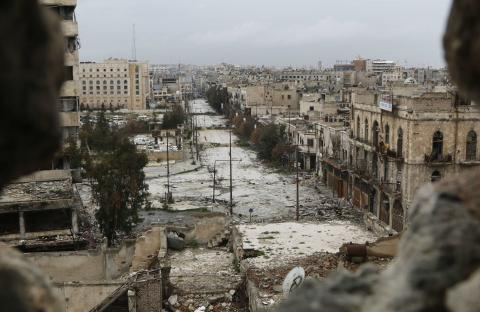 A general view shows damaged buildings along a deserted street and an area controlled by forces loyal to Syria's President Bashar Al-Assad, as seen from a rebel-controlled area at the Bab al-Nasr frontline in Aleppo, February 10, 2015. PHOTO BY REUTERS/Hosam Katan
