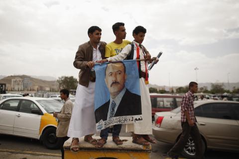 Supporters of Yemen's former President Ali Abdullah Saleh hold a poster of Saleh outside al-Saleh mosque after weekly Friday prayers in Sanaa