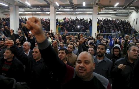 Supporters of Lebanon's Hezbollah leader Sayyed Hassan Nasrallah gesture while they are listening to his speech via a screen during a commemoration service marking one week since the killing of Hezbollah militant leader Samir Qantar, in Beirut's southern suburbs, December 27, 2015. PHOTO BY REUTERS/Aziz Taher