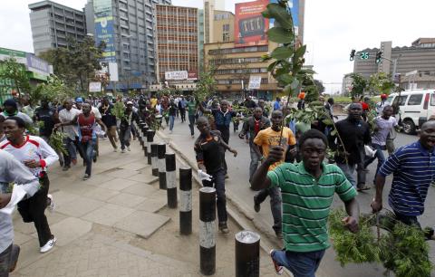 Supporters of Kenya's opposition Coalition for Reforms and Democracy (CORD) run along the streets before their "Saba Saba Day" rally demanding dialogue with the government, at the Uhuru park grounds in the capital Nairobi 