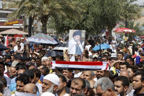 Supporters of prominent Iraqi Shi'ite cleric Moqtada al-Sadr shout slogans during a protest against government corruption after Friday prayers in Baghdad's Sadr City, April 8, 2016. PHOTO BY REUTERS/Ahmed Saad
