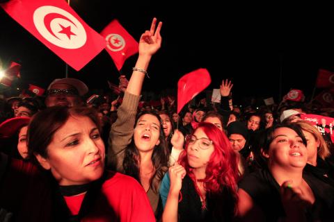 Supporters of the Nidaa Tounes (Call for Tunisia) secular party movement wave flags and shout slogans in Tunis, December 21, 2014. PHOTO BY REUTERS/Anis Mili