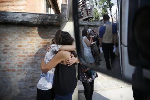 Israeli survivors from the blizzard hug each other, as they get ready to board a bus to the airport to head back to their country in Kathmandu