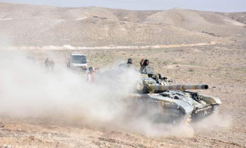 Forces loyal to Syria's President Bashar al-Assad drive a tank during their offensive to recapture the historic city of Palmyra in this picture provided by SANA on March 24, 2016. PHOTO BY REUTERS/SANA