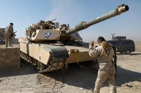 An Iraqi security forces' member directs a tank in the liberated part of Albu Saif village south of Mosul, Iraq February 21, 2017. REUTERS/Zohra Bensemra