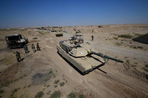 A tank of Iraqi army members and Shi'ite Popular Mobilization Forces (PMF) are seen in Al-Al-Fateha military airport south of Hawija, Iraq, October 2, 2017. PHOTO BY REUTERS/Stringer