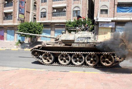 A pro-government fighter rides on a tank during clashes with Houthi fighters in Yemen's southwestern city of Taiz, October 22, 2015. PHOTO BY REUTERS/Stringer