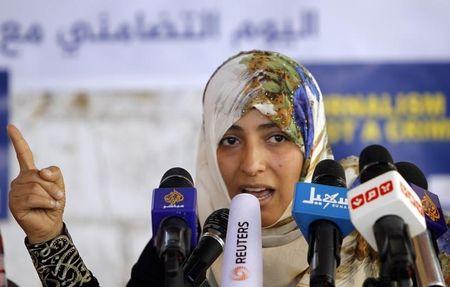 Nobel Peace Laureate Tawakul Karman speaks to a group of journalists during a protest in Sanaa, against the detainment of four Al Jazeera journalists in Egypt, February 27, 2014. PHOTO BY REUTERS/Mohamed al-Sayaghi