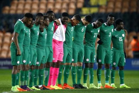 Nigeria players during a minutes silence before the match. PHOTO BY REUTERS/Peter Cziborra