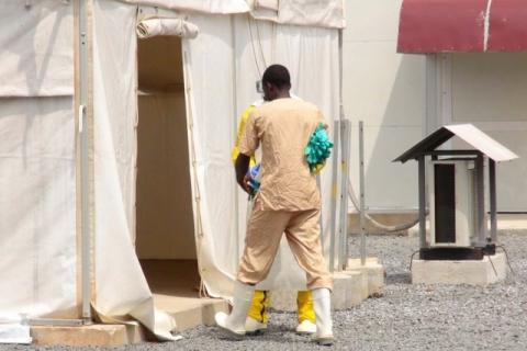 A health worker enters a tent in an Ebola virus treatment center in Conakry, Guinea, November 17, 2015. PHOTO BY REUTERS/Saliou Samb