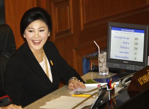 Thailand's Prime Minister Yingluck Shinawatra smiles during a no-confidence vote in Bangkok