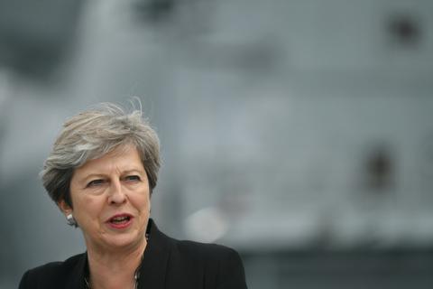 Britain's Prime Minister Theresa May stands on the flight deck as she speaks to crew members of the British aircraft carrier HMS Queen Elizabeth, during her tour of the ship, after it arrived at Portsmouth Naval base, its new home port, in Portsmouth, Britain, August 16, 2017. PHOTO BY REUTERS/Ben Stansall