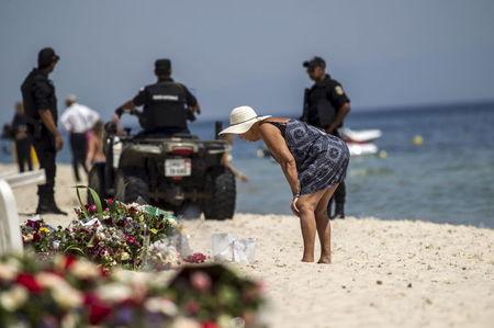 A tourist reads messages left at a makeshift memorial at the beach near the Imperial Marhaba resort, which was attacked by a gunman in Sousse, Tunisia, June 29, 2015. PHOTO BY REUTERS/Zohra Bensemra