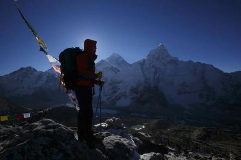 A trekker stands in front of Mount Everest, which is 8,850 meters high (C), at Kala Patthar in Solukhumbu District, May 7, 2014. PHOTO BY REUTERS/Navesh Chitrakar