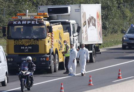 A forensic police officer stands next to a parked truck in which up to 50 migrants were found dead, on a motorway near Parndorf, Austria, August 27, 2015. PHOTO BY REUTERS/Heinz-Peter Bader