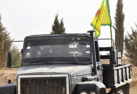 A member of the Kurdish People's Protection Units (YPG) drives a military truck with bullet-holes in the windscreen in the west of the city of Ras al-Ain, after capturing it from Islamist rebels, November 5, 2013. PHOTO BY REUTERS/Stringer