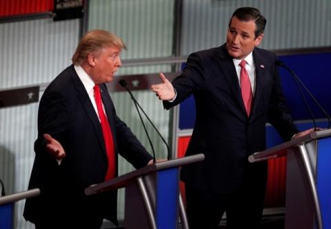 Republican U.S. presidential candidate businessman Donald Trump (L) and Senator Ted Cruz speak simultaneously at the Fox Business Network Republican presidential candidates debate in North Charleston, South Carolina, January 14, 2016. PHOTO BY REUTERS/Randall Hill