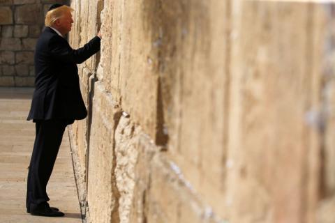 U.S. President Donald Trump places a note in the stones of the Western Wall, Judaism's holiest prayer site, in Jerusalem's Old City, May 22, 2017. PHOTO BY REUTERS/Jonathan Ernst