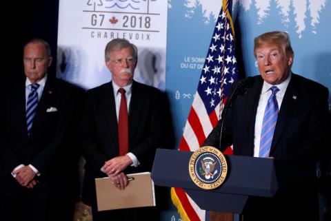 U.S. President Donald Trump gives a press briefing with U.S. National Security Advisor John Bolton and Larry Kudlow at the G7 summit in the Charlevoix city of La Malbaie, Quebec, Canada, June 9, 2018. PHOTO BY REUTERS/Leah Millis