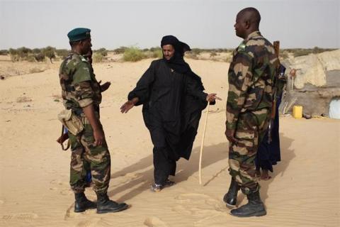 Soldiers speak with Tuareg man Alioune in the village of Tashek, outside Timbuktu