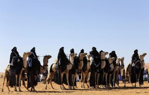 Tuareg men ride camels in the desert during the 19th Ghat Festival of Culture and Tourism, in Ghat, about 1,360 km (845 miles) south of Tripoli, December 30, 2013. PHOTO BY REUTERS/Esam Omran Al-Fetori