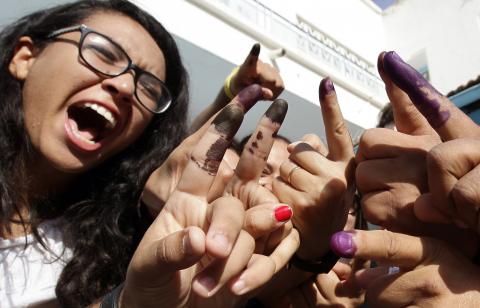 Tunisians show their ink-stained fingers after casting their votes, in Tunis October 26, 2014. Tunisians voted on Sunday in parliamentary elections that bring full democracy finally within their reach, four years after their revolution cast out autocrat Zine El-Abidine Ben Ali. PHOTO BY REUTERS/Anis Mili