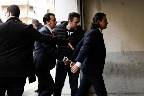 Two of the eight Turkish soldiers, who fled to Greece in a helicopter and requested political asylum after a failed military coup against the government, are escorted by police officers as they arrive at the appeals court in Athens, Greece, March 16, 2018. PHOTO BY REUTERS/Costas Baltas