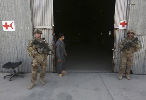 U.S. troops stand guard in front of a police medical warehouse in Kabul, August 27, 2014. PHOTO BY REUTERS/Omar Sobhani