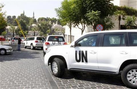United Nations vehicles transport a team of U.N. chemical weapons experts