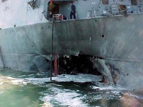 The port side damage to the guided missile destroyer USS Cole is pictured after a bomb attack during a refueling operation in the port of Aden, October 12, 2000. PHOTO BY REUTERS/Aladin Abdel Naby