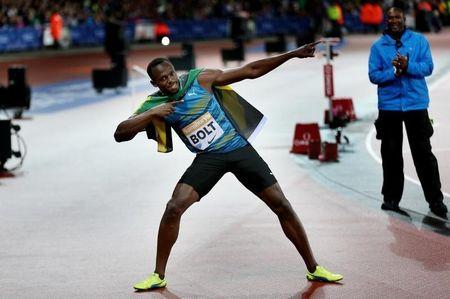 Jamaica's Usain Bolt celebrates after winning the Men's 100m Final Action. PHOTO BY REUTERS/Matthew Childs