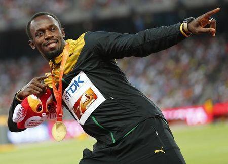 Usain Bolt of Jamaica, gold medal, reacts as he poses on the podium after the men's 200 metres event during the 15th IAAF World Championships at the National Stadium in Beijing, China, August 28, 2015. PHOTO BY REUTERS/Damir Sagolj