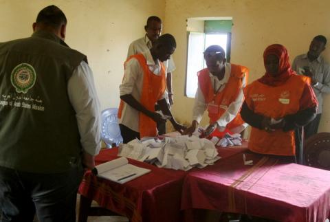 Observers watch as officials count ballots after a referendum vote in El Fasher in North Darfur, April 14, 2016. PHOTO BY REUTERS/Mohamed Nureldin Abdallah