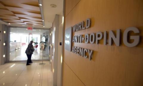 A woman walks into the head office for the World Anti-Doping Agency (WADA) in Montreal, November 9, 2015. PHOTO BY REUTERS/Christinne Muschi