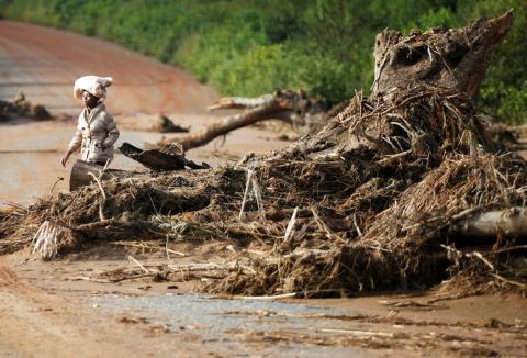 A woman walks past debris caused by Cyclone Idai near a damaged bridge in Chimanimani, Zimbabwe, March 24, 2019. PHOTO BY REUTERS/Philimon Bulawayo