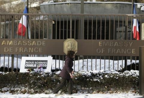 A woman walks past a French Embassy in a file photo. PHOTO BY REUTERS/Gary Cameron