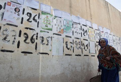 A woman walks past parliamentary election posters in Kasserine, October 23, 2014. PHOTO BY REUTERS/Zoubeir Souissi