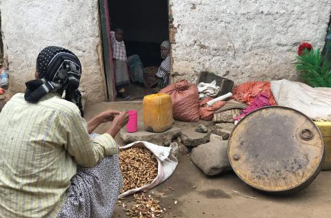 A woman prepares groundnuts outside her home in a neighbourhood where ethnic Oromos live in Harar, Ethiopia, July 22, 2018. PHOTO BY REUTERS/Maggie Fick