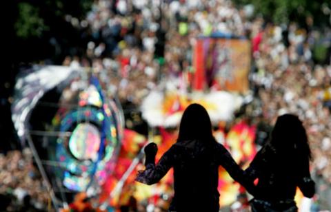 Two women are silhouetted as revellers fill the streets of London's Notting Hill during the annual carnival, August 29, 2005. Up to one million people were expected on Monday to throng London's streets for the Notting Hill Carnival, one of the world's biggest street parties. PHOTO BY REUTERS/Stephen Hird SH/ASA