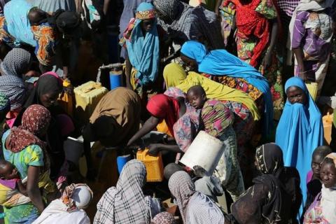 Women gather to collect water at a motorised borehole at the Muna Internally displace people camp in Maiduguri, Nigeria, December 1, 2016. PHOTO BY REUTERS/Afolabi Sotunde