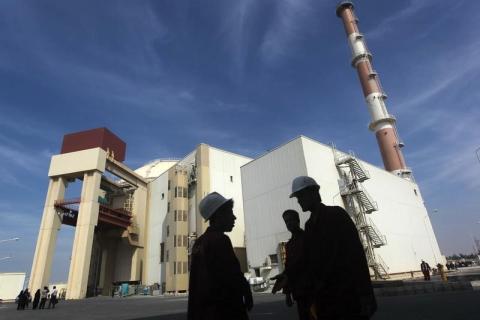 Iranian workers stand in front of the Bushehr nuclear power plant, about 1,200 km (746 miles) south of Tehran